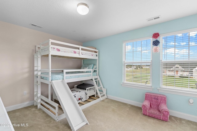 bedroom featuring carpet, visible vents, and baseboards