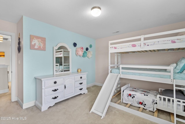 bedroom featuring light carpet, visible vents, and baseboards