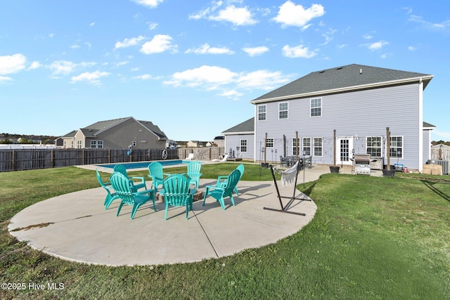 rear view of house featuring a patio area, a fenced backyard, a residential view, and a lawn