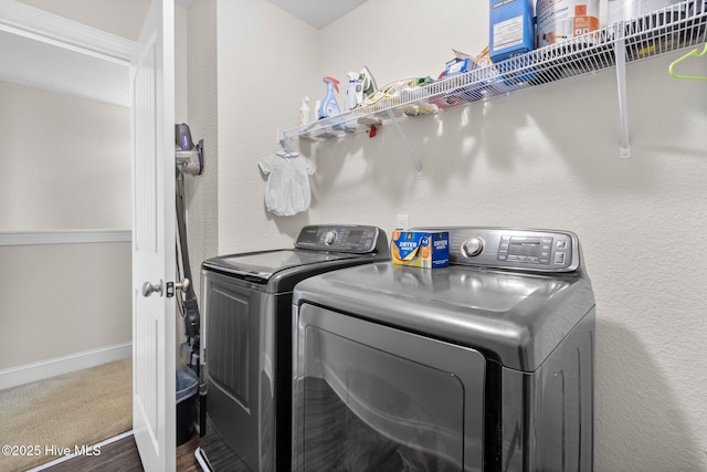 laundry area featuring washer and dryer, laundry area, carpet flooring, and baseboards