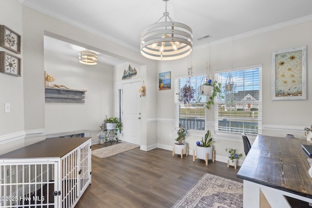 interior space with dark wood-style flooring, crown molding, visible vents, a chandelier, and baseboards