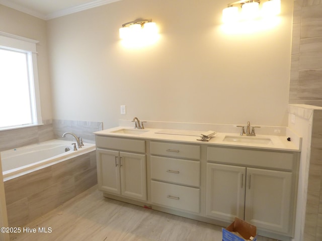 full bathroom featuring ornamental molding, a sink, a bath, and double vanity