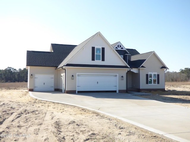 view of front of house with a garage and concrete driveway