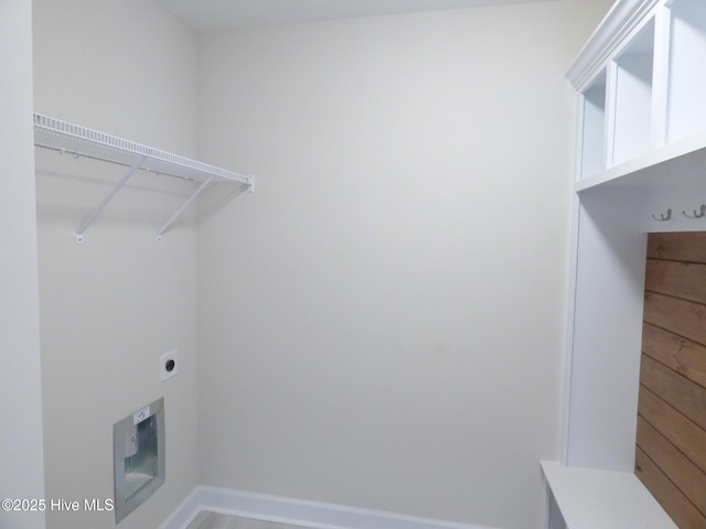 washroom featuring laundry area, baseboards, and electric dryer hookup