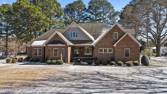 craftsman-style house featuring brick siding