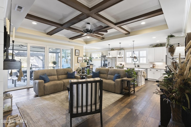 living room featuring beamed ceiling, coffered ceiling, and visible vents