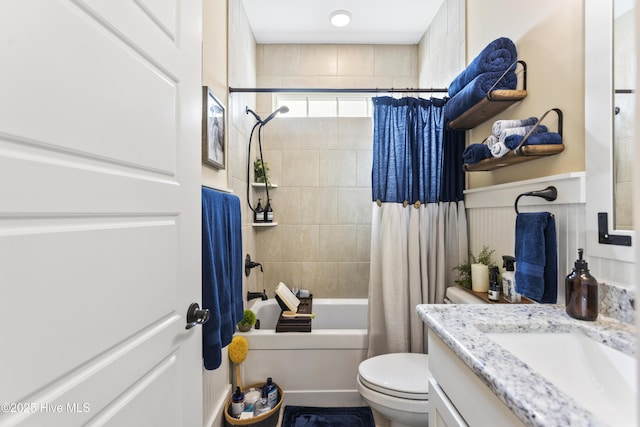 bathroom with vanity, toilet, and shower / tub combo with curtain