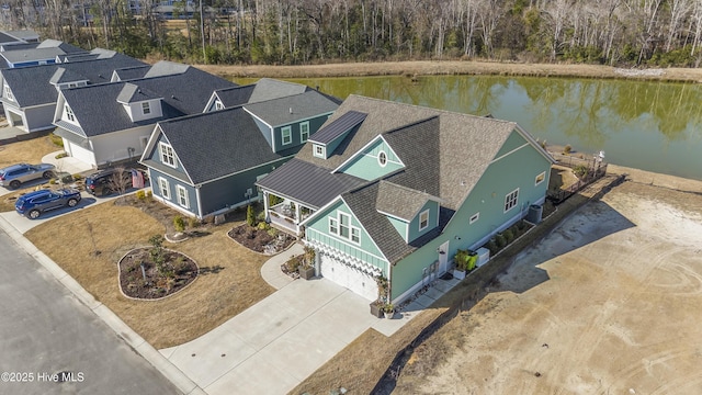 birds eye view of property with a water view