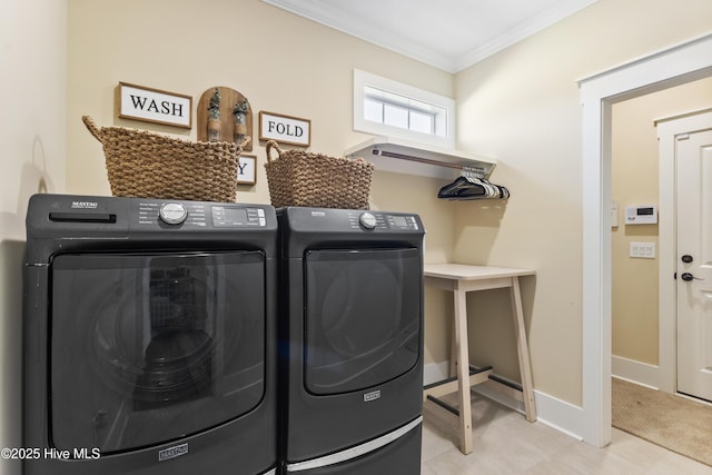 washroom with laundry area, baseboards, ornamental molding, and washer and clothes dryer