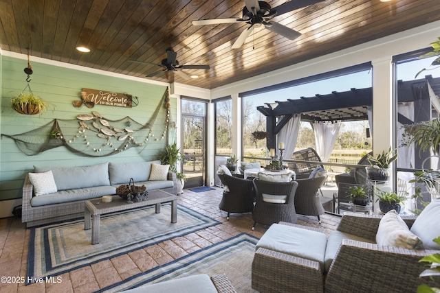 sunroom / solarium with wooden ceiling and a ceiling fan