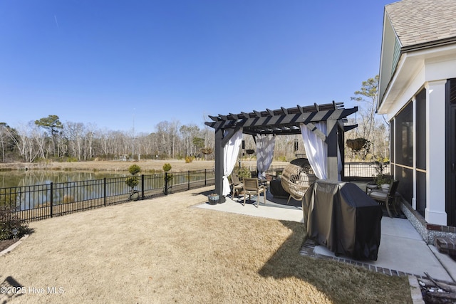 view of yard with a water view, a fenced backyard, a pergola, and a patio