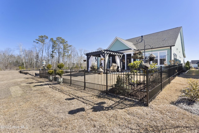 view of front of home featuring a patio area, fence, and a pergola