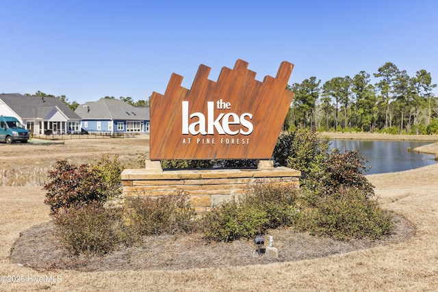 community sign with a water view