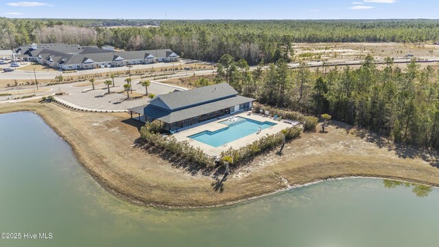 aerial view featuring a water view and a wooded view