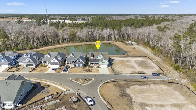 bird's eye view with a water view, a residential view, and a view of trees