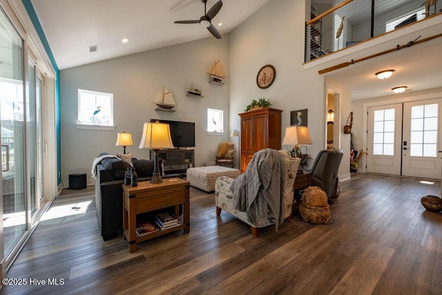 living room featuring dark wood-style floors, french doors, and high vaulted ceiling