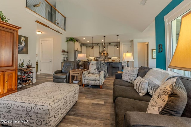 living room featuring high vaulted ceiling, dark wood-type flooring, and recessed lighting