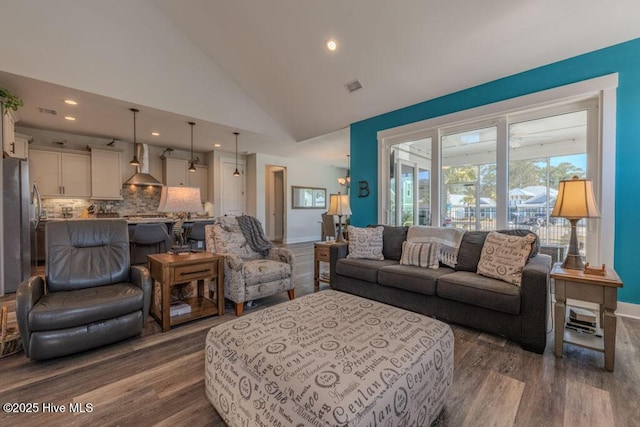 living room featuring dark wood-style flooring, recessed lighting, visible vents, high vaulted ceiling, and baseboards