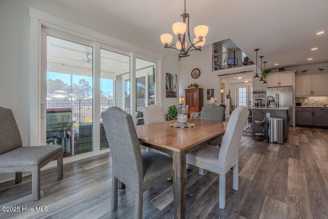 dining space featuring dark wood-style floors, a notable chandelier, and recessed lighting