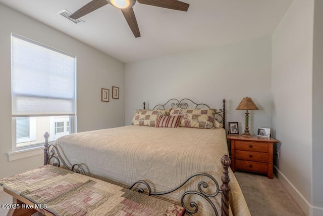 bedroom with light carpet, ceiling fan, visible vents, and baseboards