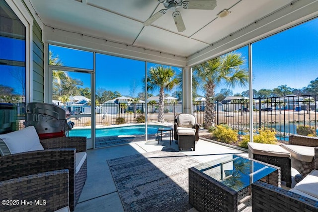 sunroom / solarium featuring a ceiling fan