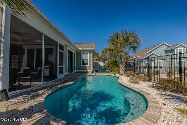 view of pool with a sunroom, fence, and a fenced in pool