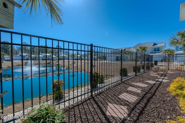 view of pool with a water view and fence