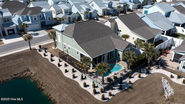 drone / aerial view featuring a water view and a residential view