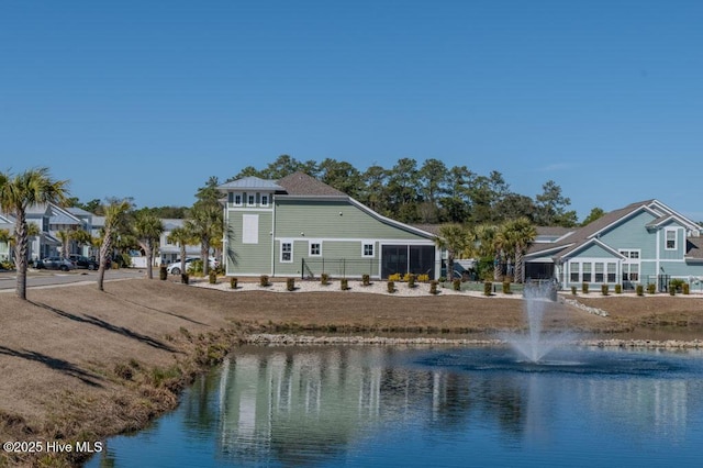 back of house with a water view