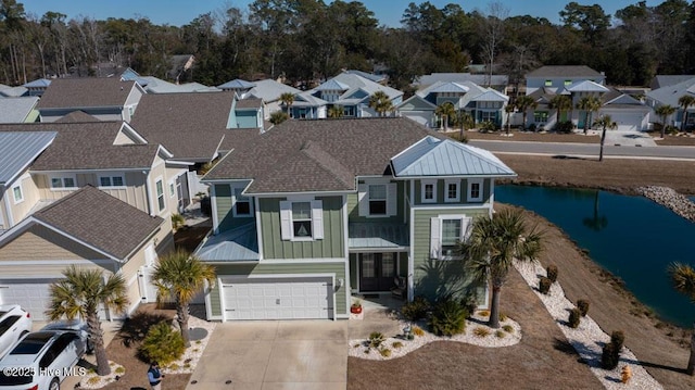 view of front of house featuring concrete driveway, board and batten siding, an attached garage, and a residential view