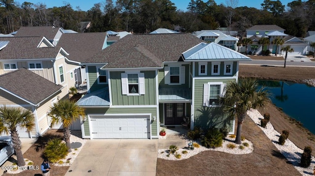 view of front of home featuring an attached garage, a residential view, board and batten siding, and concrete driveway