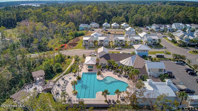 birds eye view of property with a residential view and a view of trees