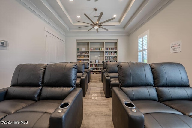 living area with light wood-type flooring, a raised ceiling, ceiling fan, and recessed lighting