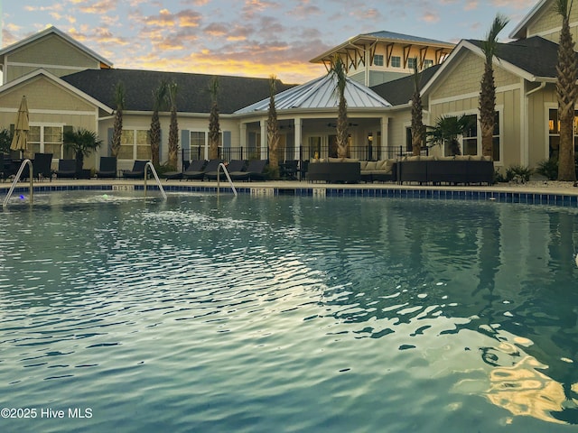 community pool featuring a patio area and fence