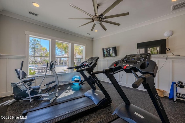 workout room featuring visible vents, crown molding, and a decorative wall