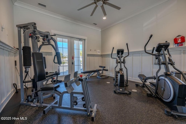 exercise area with a wainscoted wall, visible vents, crown molding, and french doors