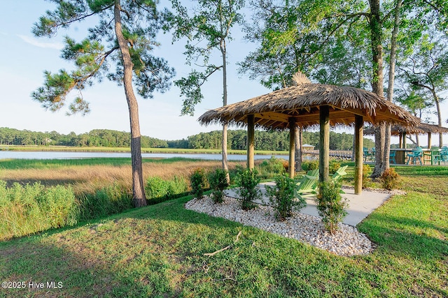 surrounding community featuring a water view, a lawn, and a gazebo