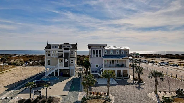 exterior space with a water view and stairs