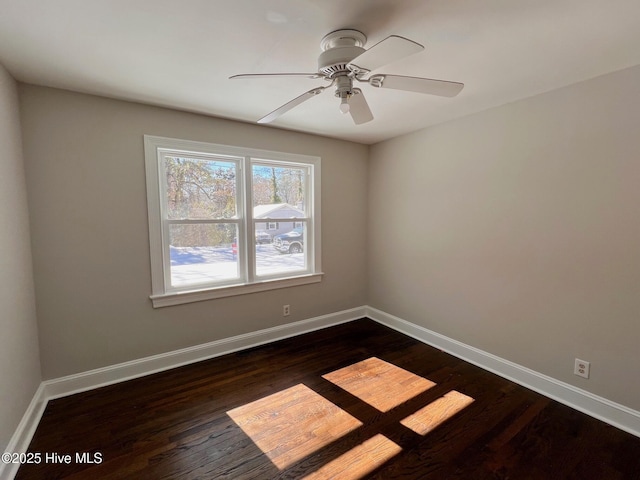 unfurnished room featuring ceiling fan, baseboards, and dark wood finished floors