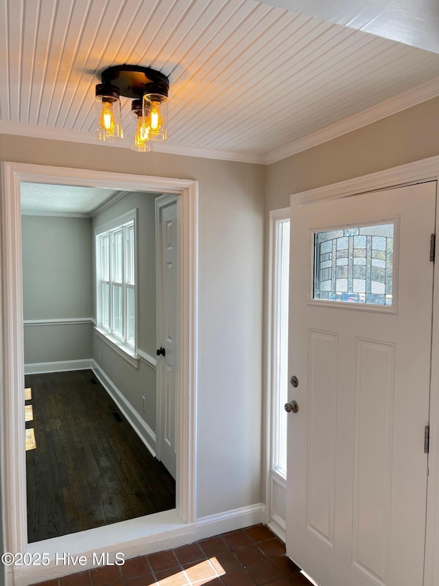 foyer entrance featuring wood ceiling, baseboards, and ornamental molding