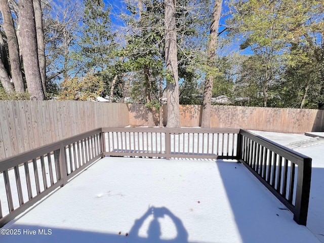 wooden terrace featuring a patio area and a fenced backyard