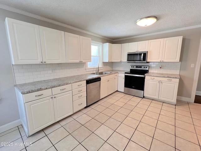 kitchen featuring stainless steel appliances, a sink, white cabinetry, ornamental molding, and decorative backsplash