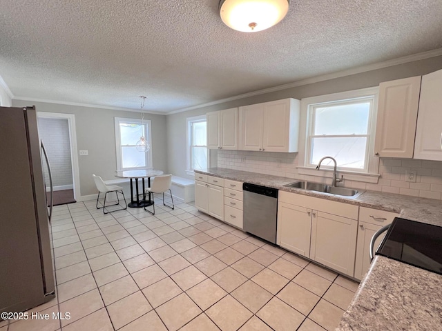 kitchen with stainless steel appliances, white cabinetry, a sink, and crown molding