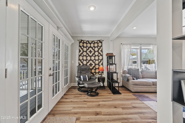 living area featuring french doors, crown molding, recessed lighting, wood finished floors, and baseboards