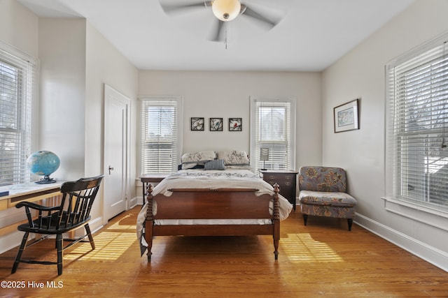 bedroom featuring light wood finished floors, baseboards, and a ceiling fan