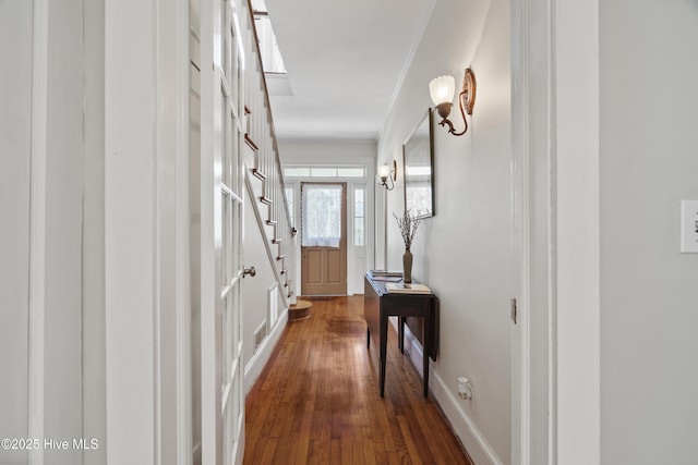 hallway featuring baseboards and wood finished floors