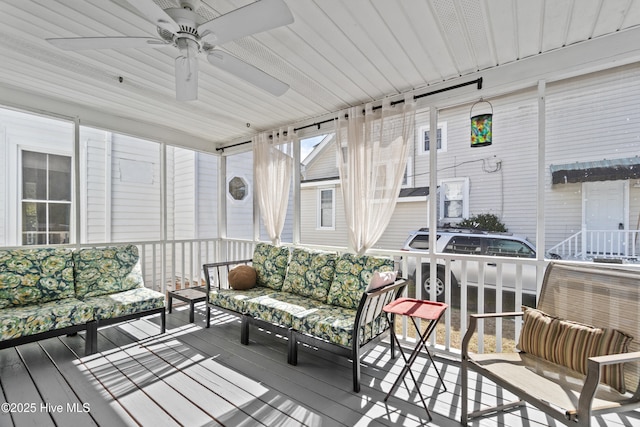 sunroom / solarium featuring ceiling fan