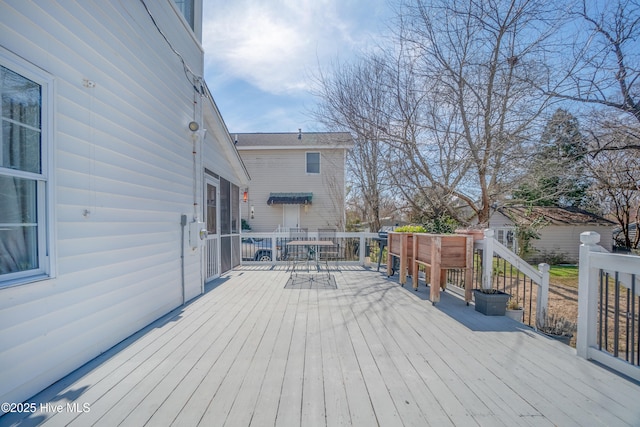 deck with outdoor dining area