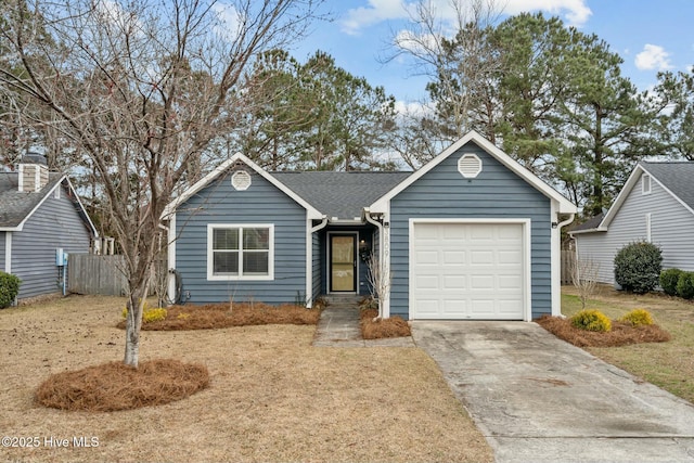 ranch-style home with driveway, a shingled roof, an attached garage, and fence