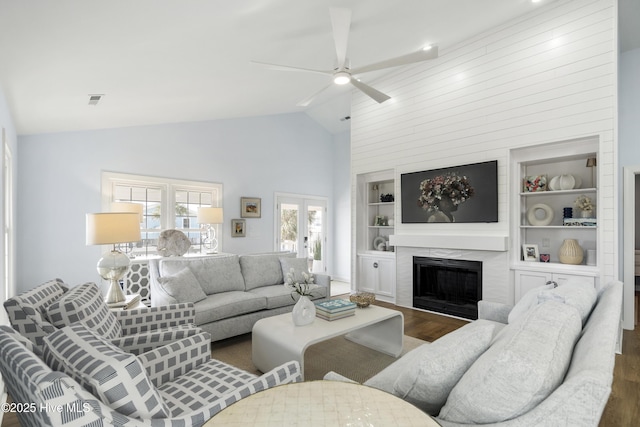 212 Florida Ave, Carolina Beach, NC 28428 - living area featuring wood finished floors, a ceiling fan, a high end fireplace, built in features, and high vaulted ceiling